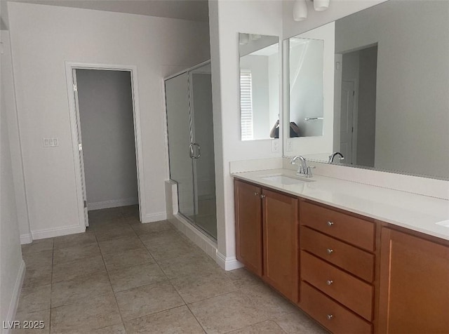 full bath with vanity, tile patterned flooring, baseboards, and a shower stall