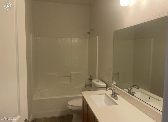 bathroom featuring toilet, shower / tub combination, wood finished floors, and vanity