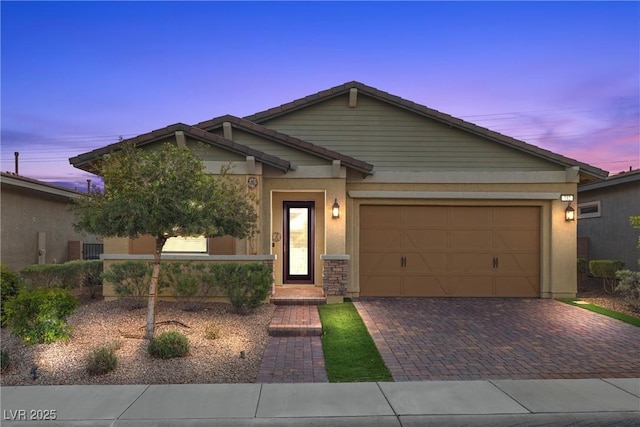 732 Rosewater Dr, Henderson, NV 89011 - view of front of home with decorative driveway, an attached garage, stucco siding, and a tiled roof