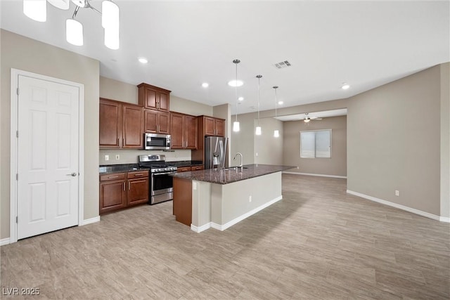 732 Rosewater Dr, Henderson, NV 89011 - kitchen with appliances with stainless steel finishes, a sink, baseboards, a kitchen island with sink, and recessed lighting