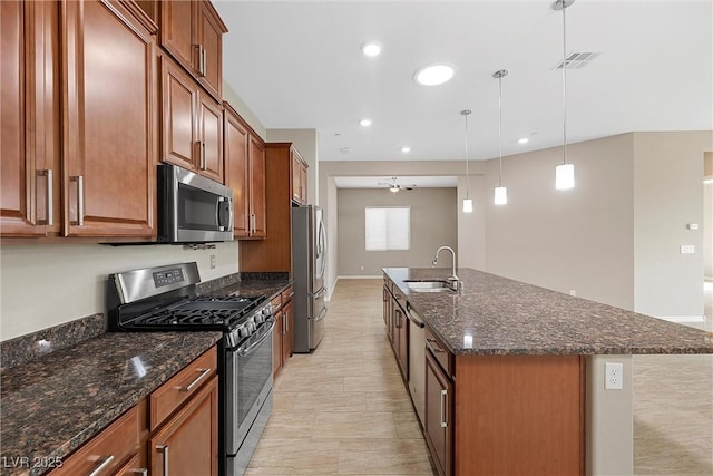 732 Rosewater Dr, Henderson, NV 89011 - kitchen featuring appliances with stainless steel finishes, a sink, an island with sink, dark stone counters, and recessed lighting