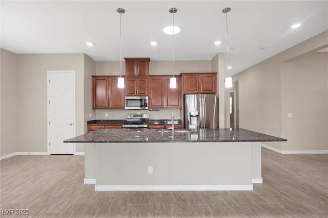 732 Rosewater Dr, Henderson, NV 89011 - kitchen featuring appliances with stainless steel finishes, an island with sink, a sink, baseboards, and dark stone counters