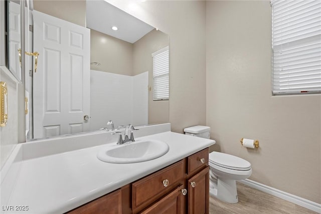 732 Rosewater Dr, Henderson, NV 89011 - full bath with toilet, vanity, wood finished floors, a shower, and baseboards