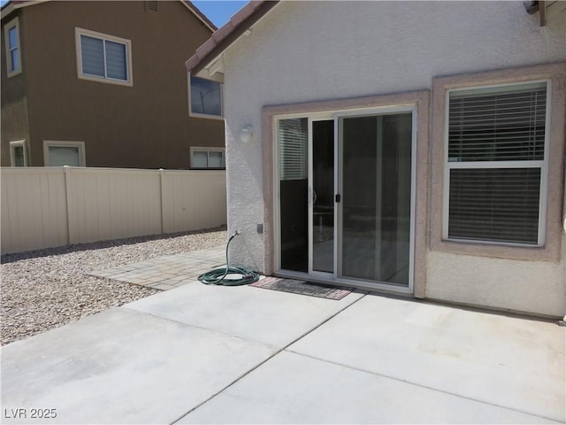 view of patio featuring fence