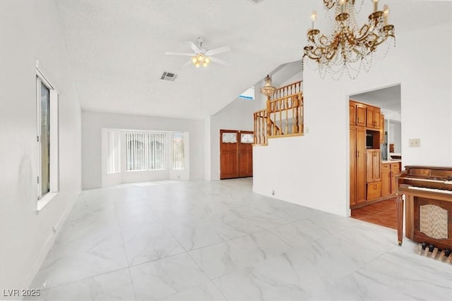 living room featuring stairway, high vaulted ceiling, ceiling fan with notable chandelier, marble finish floor, and visible vents