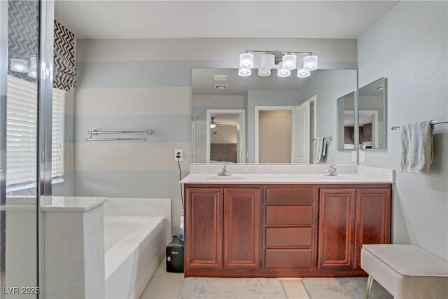 651 Penshaw Bridge Ave, Las Vegas, NV 89178 - bathroom featuring a bath, double vanity, a ceiling fan, and tile patterned flooring