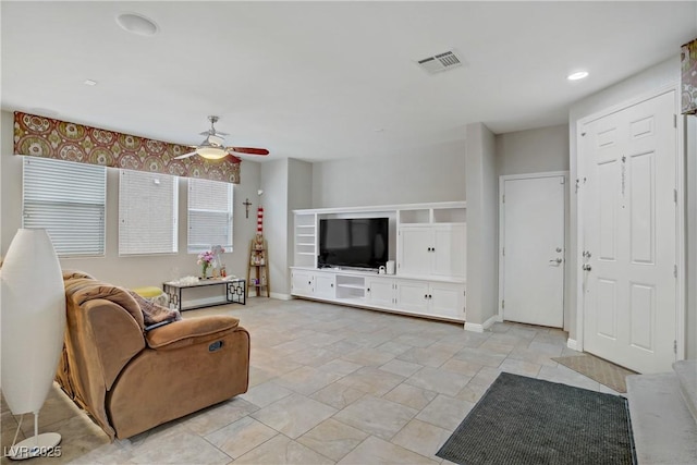651 Penshaw Bridge Ave, Las Vegas, NV 89178 - living room featuring a ceiling fan and light stone finish floors