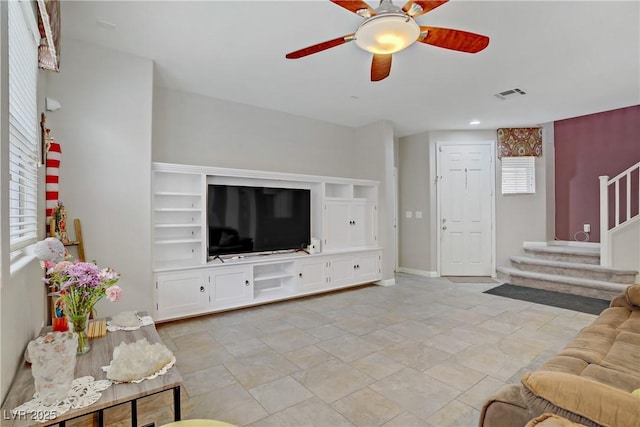 651 Penshaw Bridge Ave, Las Vegas, NV 89178 - living room with stairs, ceiling fan, and light stone finish floors