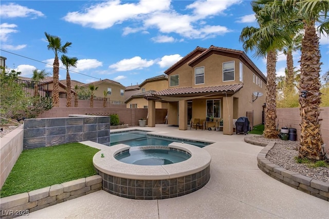 651 Penshaw Bridge Ave, Las Vegas, NV 89178 - back of property featuring stucco siding, a patio, a fenced backyard, a pool with connected hot tub, and a tiled roof