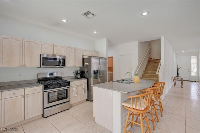 775 Wigan Pier Dr, Henderson, NV 89002 - kitchen featuring light tile patterned flooring, a sink, a kitchen breakfast bar, appliances with stainless steel finishes, and visible vents