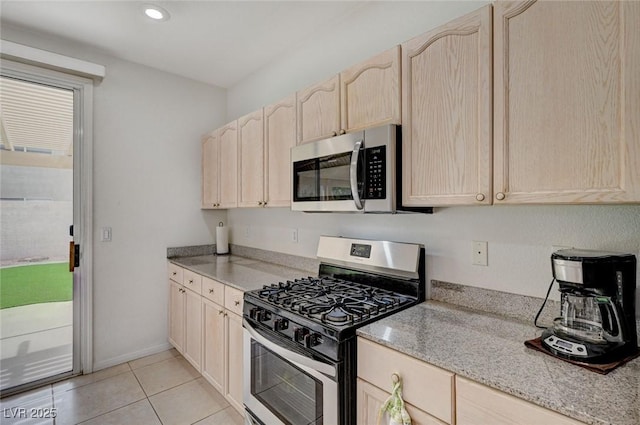 775 Wigan Pier Dr, Henderson, NV 89002 - kitchen featuring light stone countertops, light brown cabinetry, light tile patterned floors, stainless steel appliances, and recessed lighting
