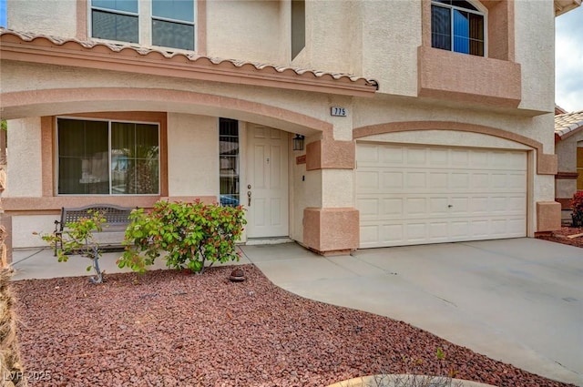 775 Wigan Pier Dr, Henderson, NV 89002 - exterior space with stucco siding, an attached garage, a porch, and driveway