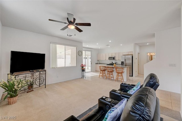 775 Wigan Pier Dr, Henderson, NV 89002 - living room featuring visible vents, recessed lighting, a ceiling fan, light tile patterned floors, and light colored carpet