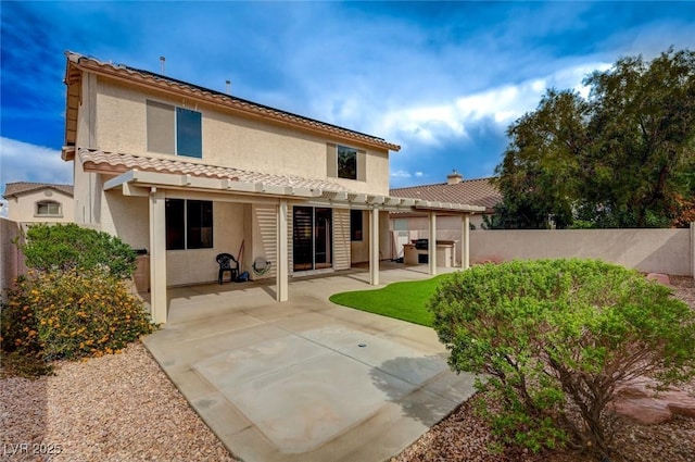 775 Wigan Pier Dr, Henderson, NV 89002 - rear view of property featuring a fenced backyard, stucco siding, a tiled roof, and a patio