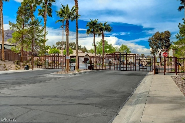 775 Wigan Pier Dr, Henderson, NV 89002 - view of street featuring a gate, curbs, sidewalks, traffic signs, and a gated entry