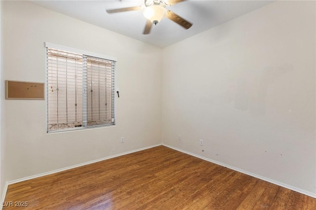 unfurnished room with baseboards, a ceiling fan, and wood finished floors