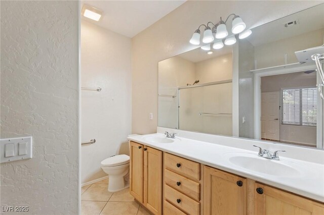 bathroom featuring a sink, tile patterned floors, toilet, and visible vents