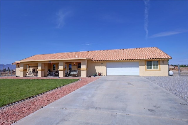 ranch-style house featuring a garage, a front yard, stucco siding, a tiled roof, and driveway