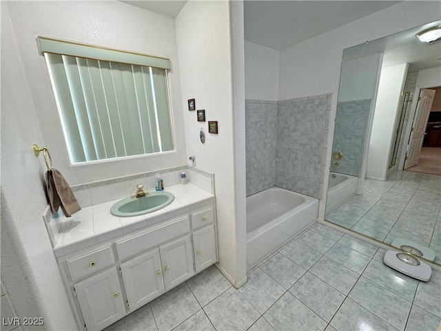 full bath featuring a washtub, tile patterned floors, and vanity