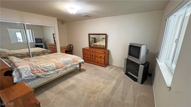 bedroom with carpet, a closet, and visible vents