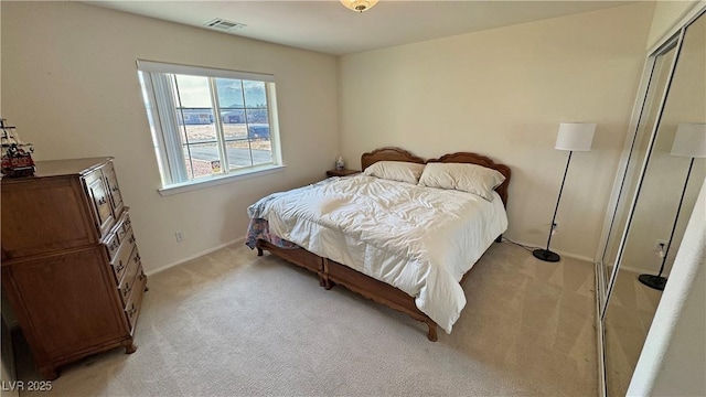 bedroom featuring light colored carpet, baseboards, and visible vents