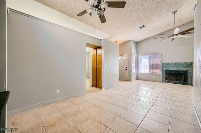unfurnished living room featuring a ceiling fan, light tile patterned floors, and lofted ceiling