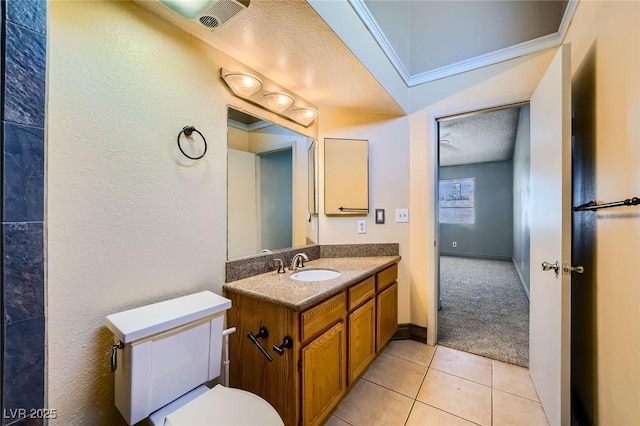 bathroom featuring tile patterned flooring, visible vents, vanity, toilet, and a textured ceiling