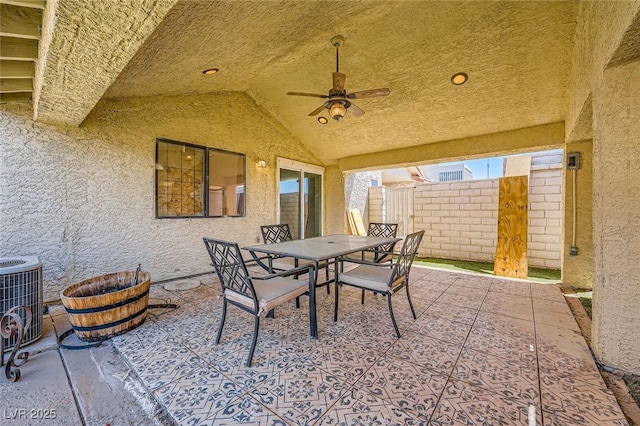 view of patio with cooling unit, ceiling fan, fence, and outdoor dining space