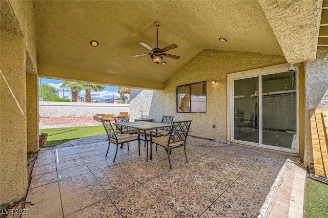 view of patio / terrace featuring fence, outdoor dining area, and ceiling fan