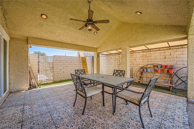 view of patio featuring fence, outdoor dining space, and ceiling fan