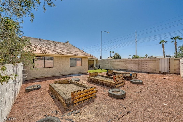 view of yard featuring a garden and a fenced backyard