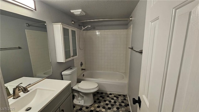 full bathroom featuring tile patterned flooring, toilet, vanity, shower / tub combination, and a textured ceiling