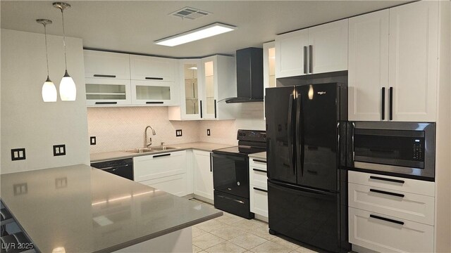 kitchen with backsplash, wall chimney range hood, a sink, black appliances, and a peninsula