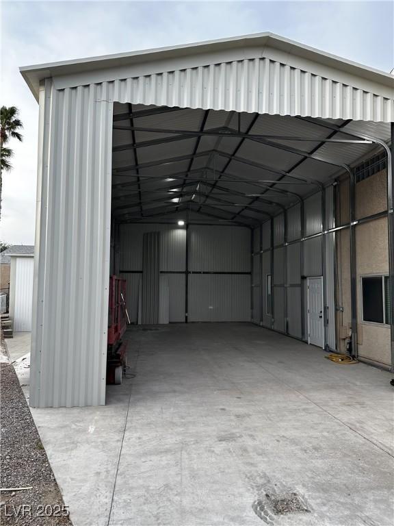 garage featuring a carport and driveway