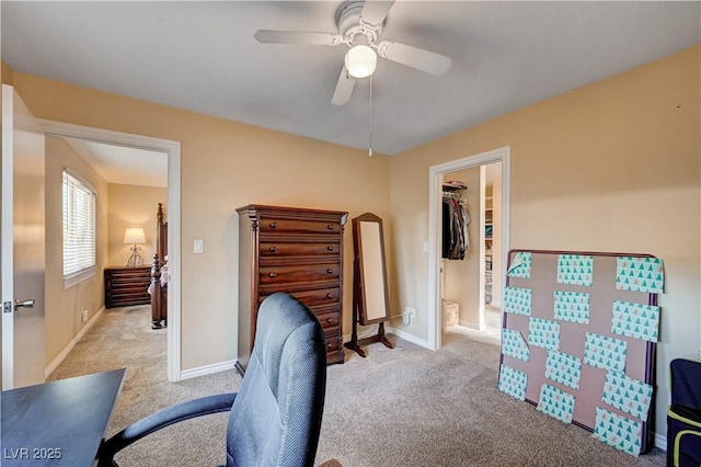 office area featuring a ceiling fan, baseboards, and carpet