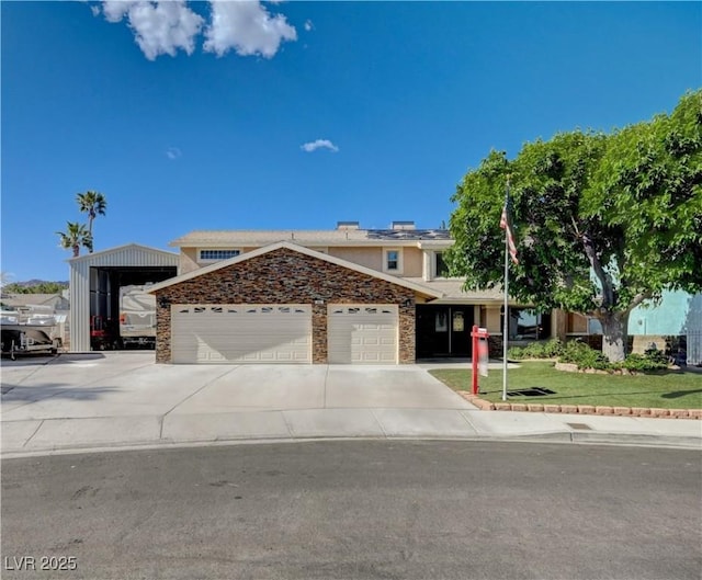 view of front of property featuring an attached garage, concrete driveway, stucco siding, and a front yard