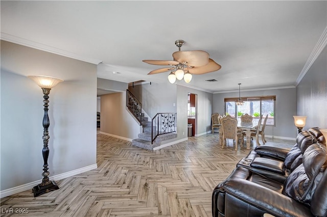 living room with ceiling fan, visible vents, baseboards, ornamental molding, and stairs