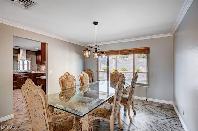 dining area with crown molding, baseboards, and visible vents