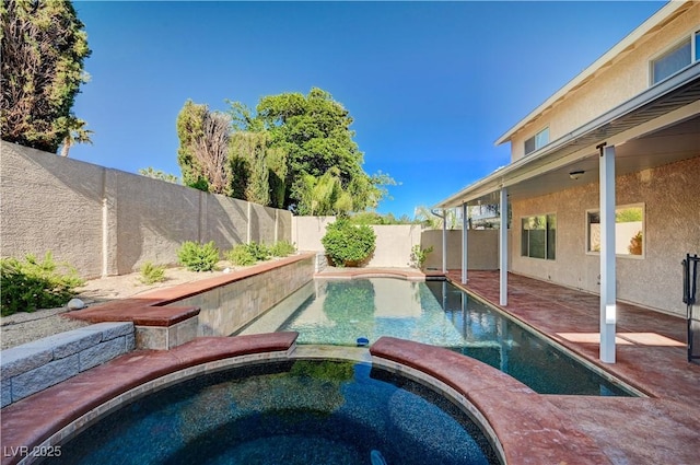 view of swimming pool featuring an in ground hot tub, a fenced in pool, a fenced backyard, and a patio area
