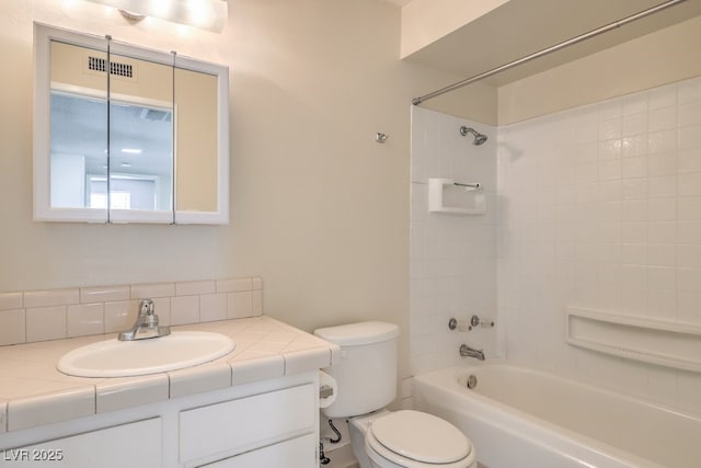 bathroom featuring visible vents, washtub / shower combination, vanity, and toilet