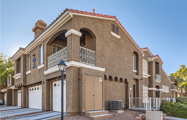 view of building exterior featuring central AC unit and an attached garage