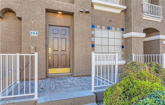 doorway to property with stucco siding