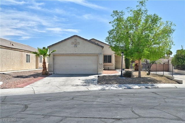 single story home with a garage, stucco siding, fence, and concrete driveway