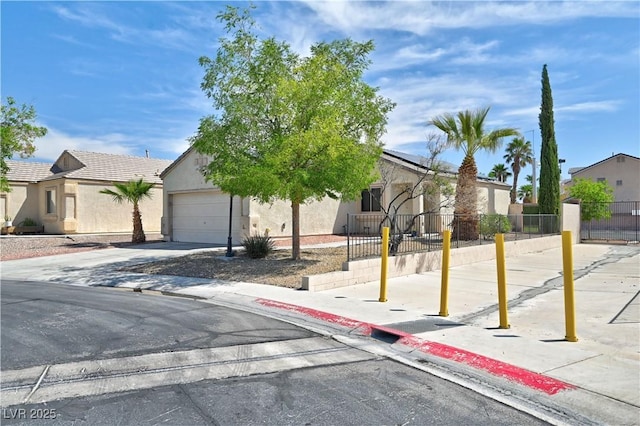 view of front facade with stucco siding, fence, and solar panels