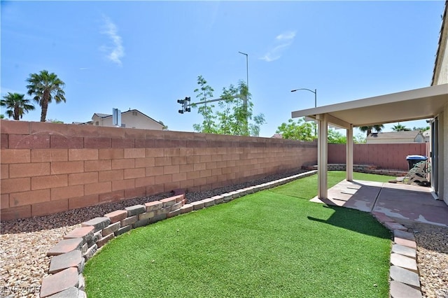 view of yard with a patio area and a fenced backyard