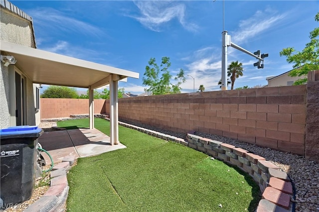 view of yard with a fenced backyard and a patio area