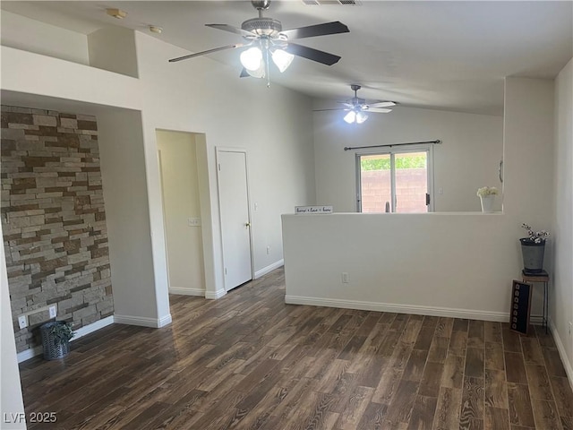 unfurnished room with vaulted ceiling, visible vents, a ceiling fan, baseboards, and dark wood-style flooring
