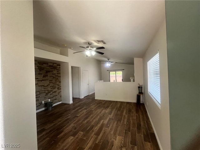 unfurnished living room with dark wood finished floors, vaulted ceiling, baseboards, visible vents, and a ceiling fan