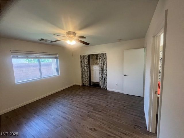 unfurnished bedroom with visible vents, a ceiling fan, a closet, baseboards, and dark wood-style flooring