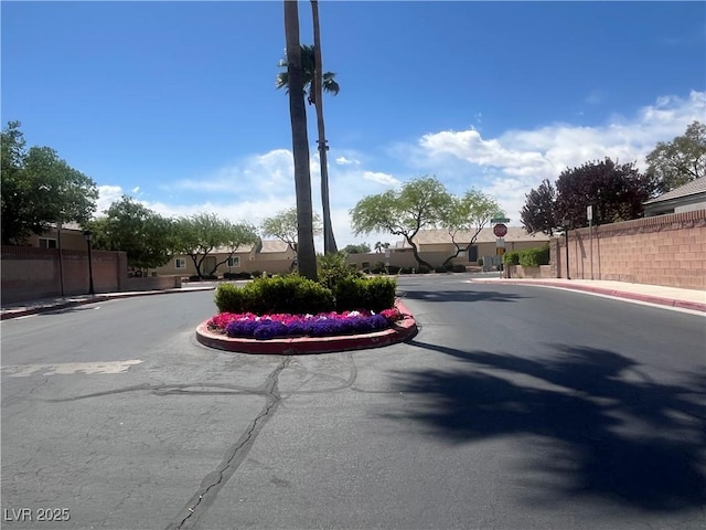 view of street with curbs, sidewalks, and traffic signs